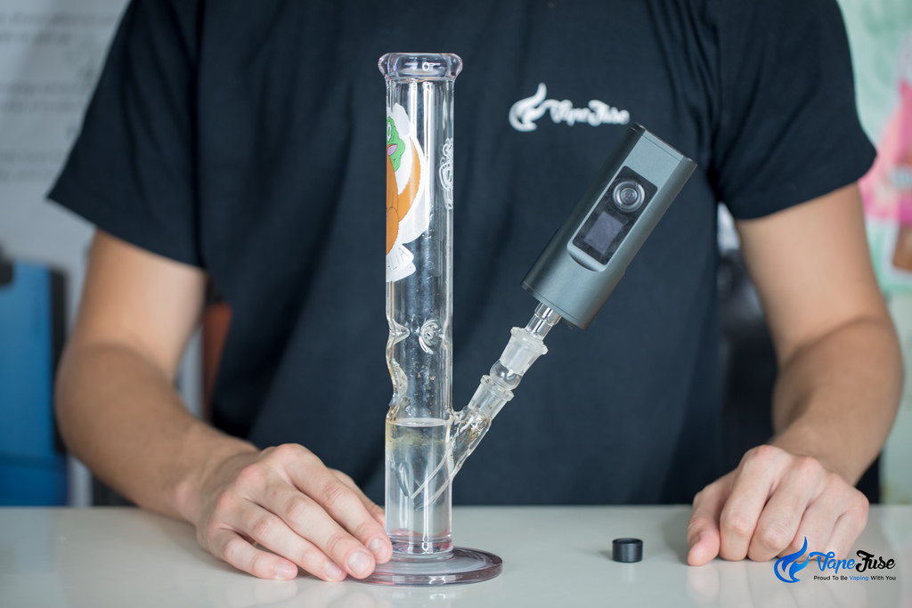 Arizer Solo II Portable Vaporizer connected to a water pipe with a frosted glass bong attachment